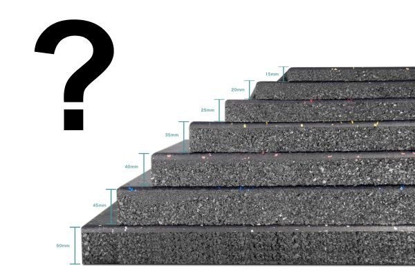 Stack of black rubber gym mats in different thicknesses for gym flooring